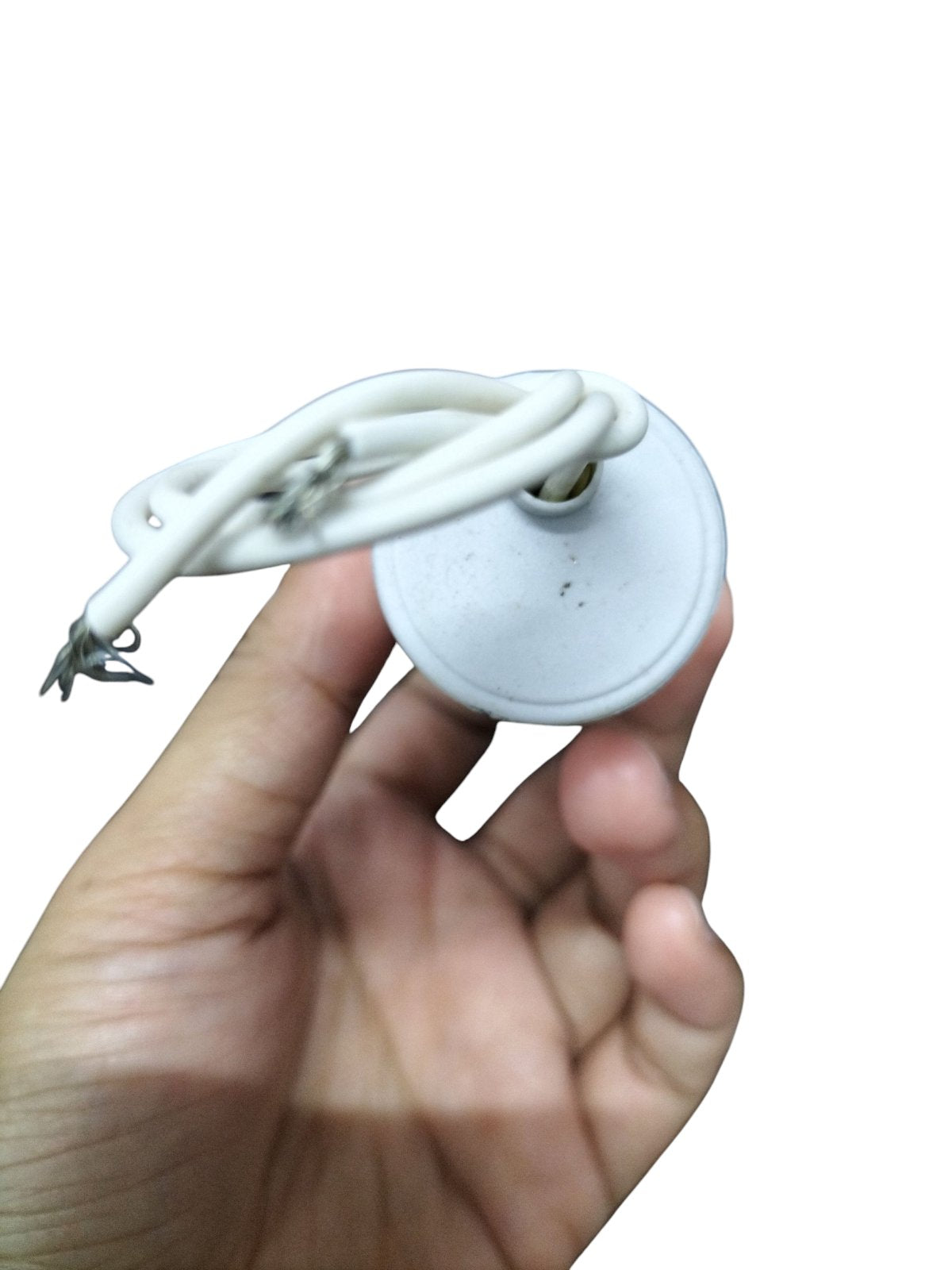 Hand holding a Syscap Motor Running Capacitor 250 VAC with attached wires and a round casing