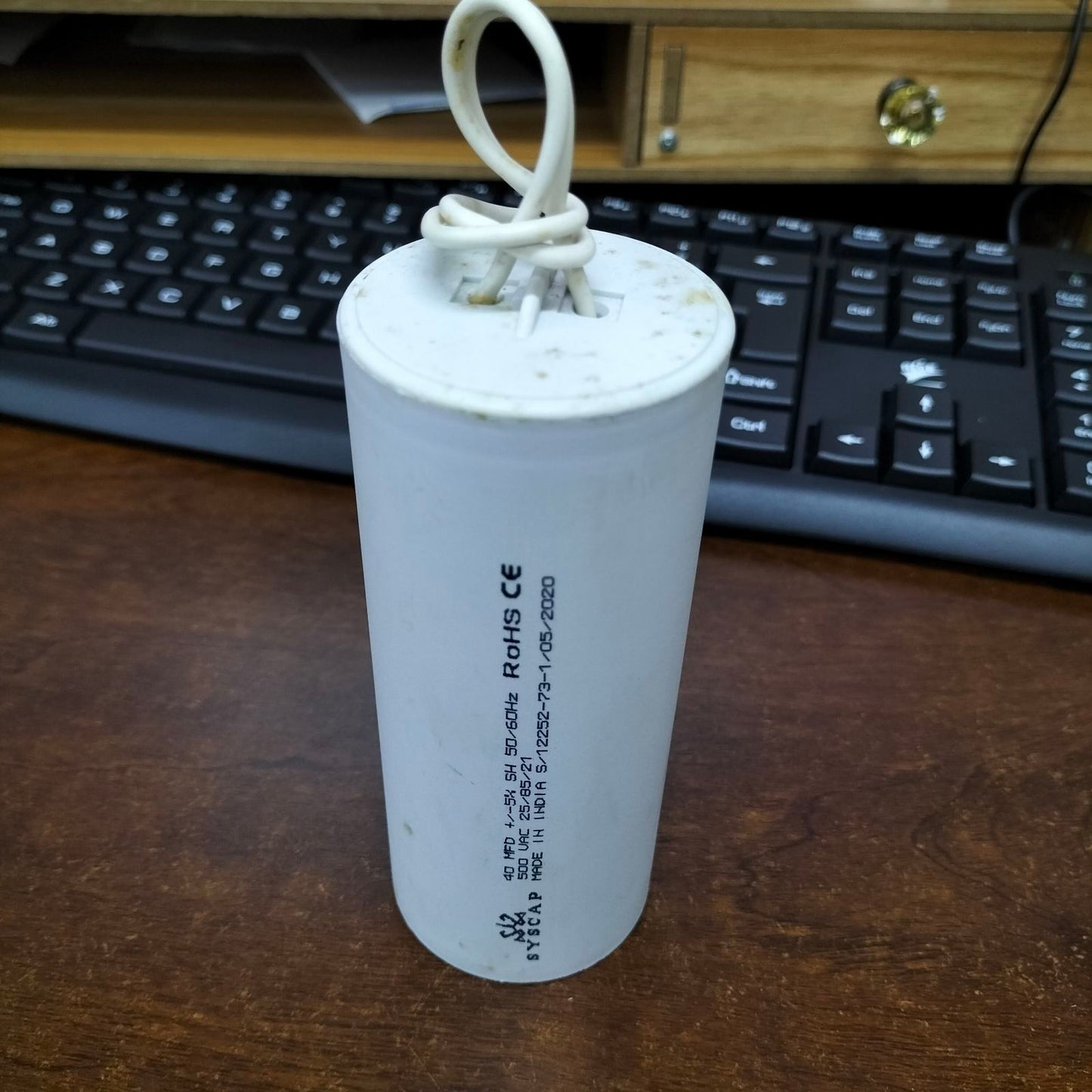 SYSCAP motor running capacitor 40uF 500V with a white cylindrical body for reliable motor performance