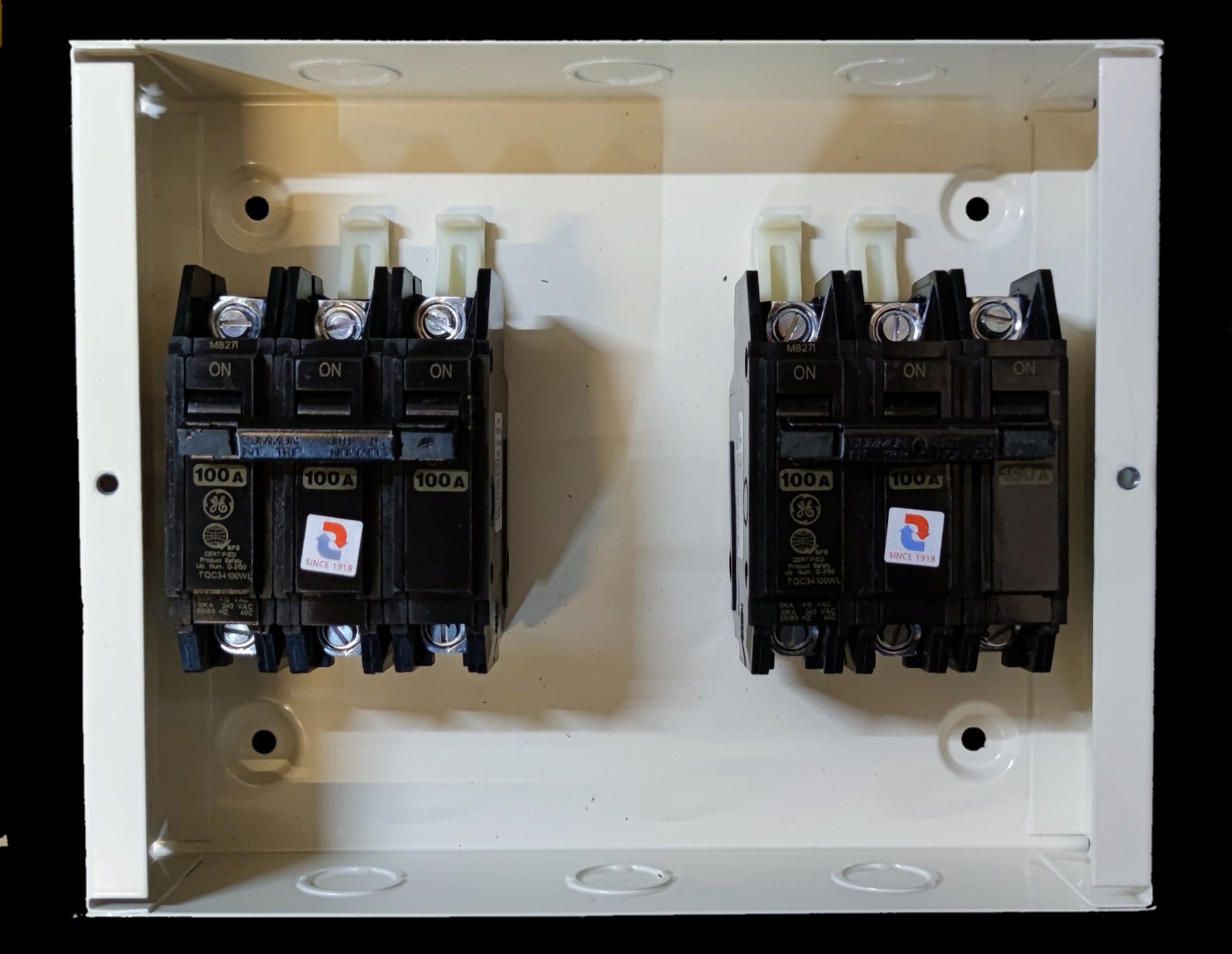 Koten and GE MTS 100A 3 Pole Three Phase electrical circuit breakers mounted in a white metal box