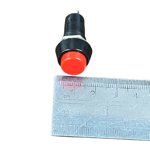 Normally Open Monetary Switch Red 1A with a push button design next to a ruler for size reference