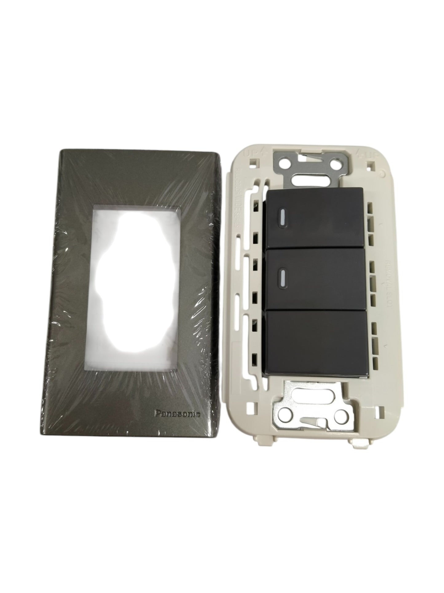 Panasonic 3 gang switch with black rocker panels and separate metallic faceplate in packaging
