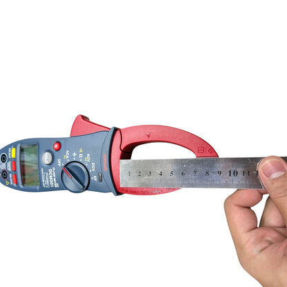 Digital multimeter with a ruler held by a hand on a white background Sanwa Digital AC Clamp Meter DCM301 Measure True RMS Method ACA 60A/600A/1000A Made In Japan Electx Electrical SUpply