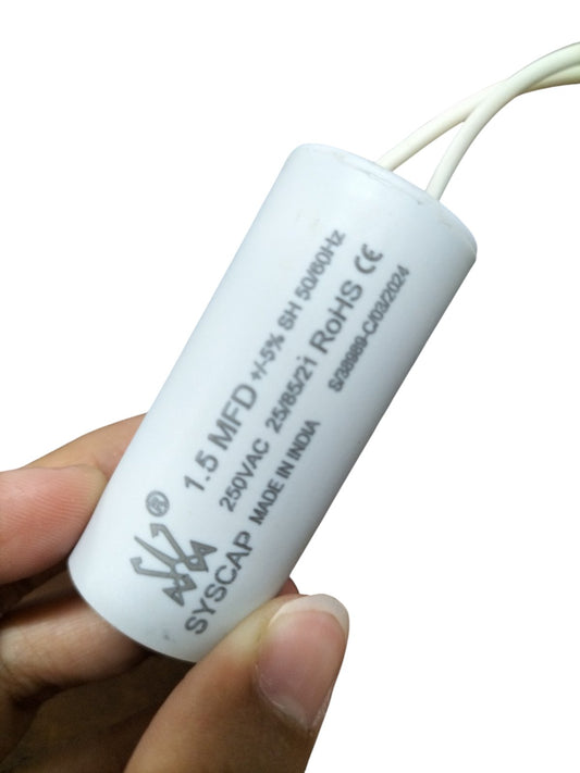 Syscap 1.5MFD 250V AC Motor Run Capacitor held between fingers, white cylindrical electrical component