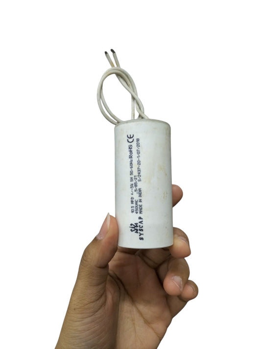 Syscap 10.5MFD 450 VAC Running Capacitor held in hand for electrical circuitry and parts