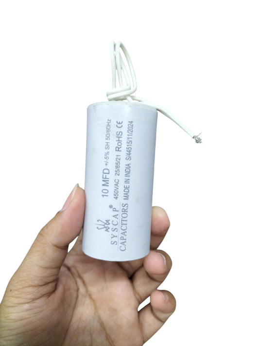 Syscap 10MFD 450 VAC Running Capacitor held in hand with white cylindrical body and attached wires