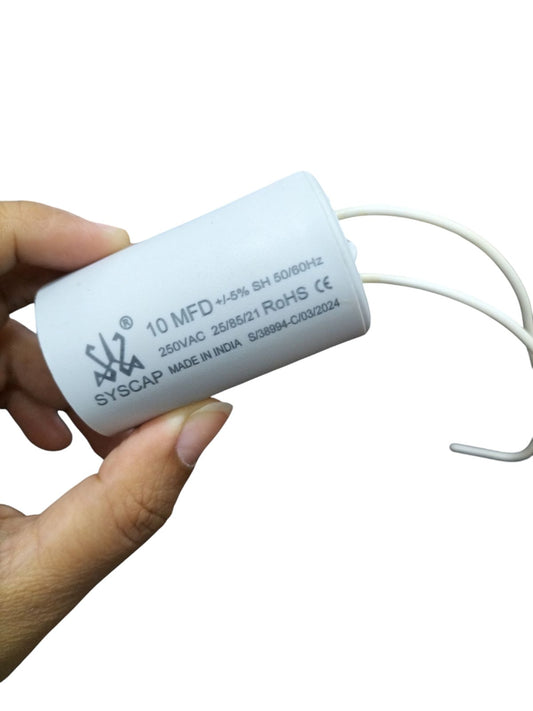 CBB 10MFD motor running capacitor white electrical component with wires held in hand