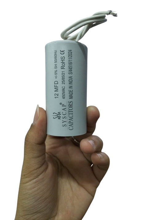 Syscap 12MFD motor capacitor held in hand electrical circuitry part for motor repair
