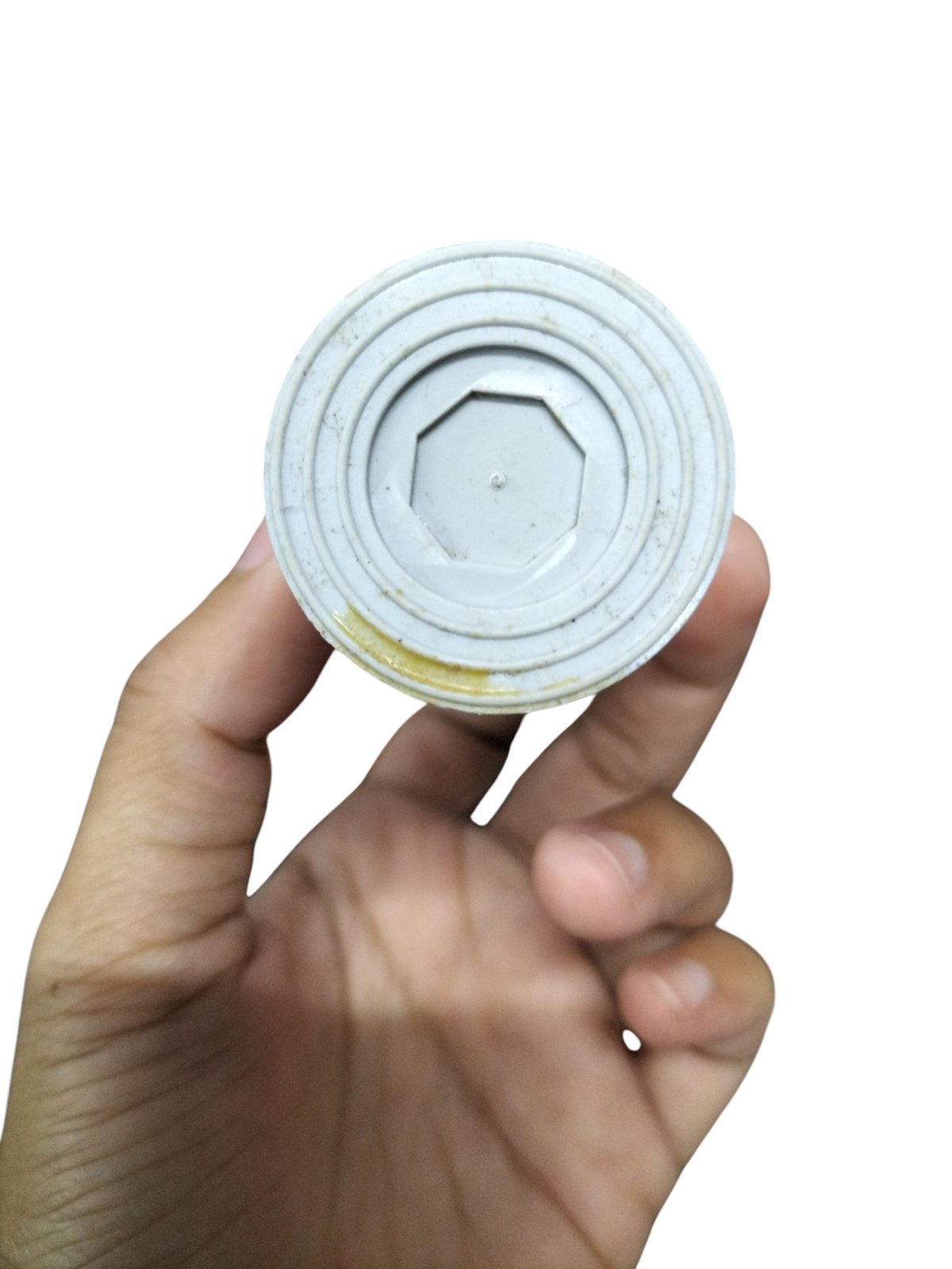 Hand holding a 14MFD 250 VAC Running Capacitor from Syscap with a detailed bottom view