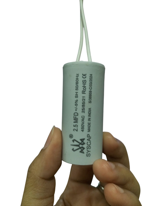 Syscap 2.5MFD 450V AC Running Capacitor held between fingers for electrical circuitry