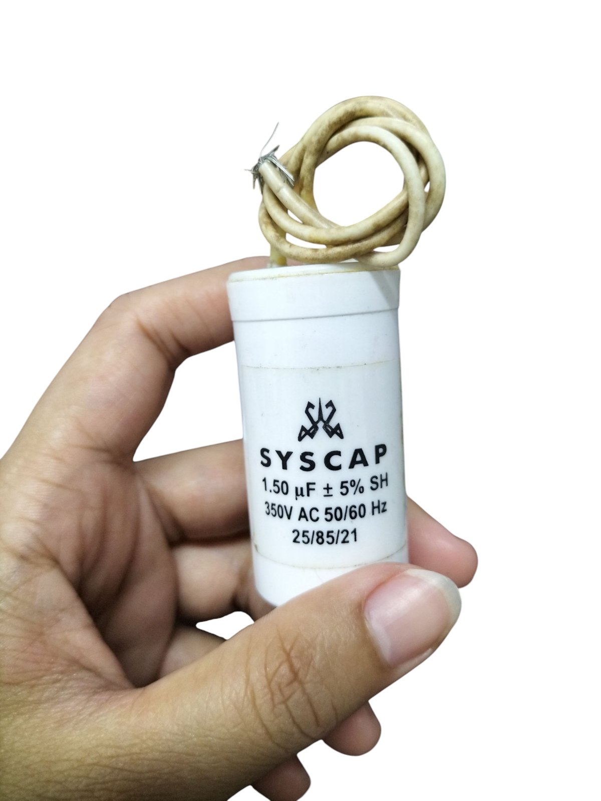 SYSCAP 350VAC running capacitor with 1.50 μF rating held in hand for electrical applications