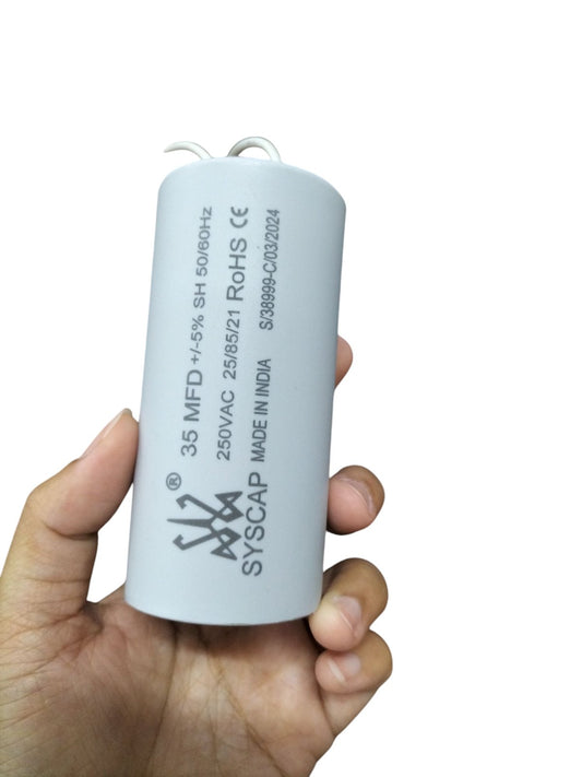 Syscap 35MFD Motor Running Capacitor held in hand for electrical circuitry and parts