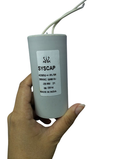 Syscap 40MFD 350 VAC Running Capacitor electrical component held in hand with wires attached