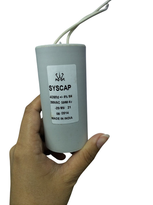 Syscap 40MFD 350 VAC Running Capacitor electrical component held in hand with wires attached