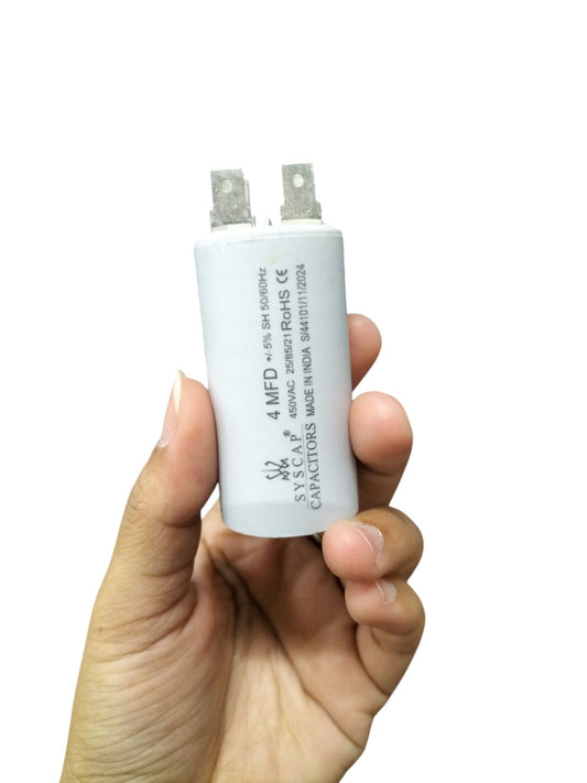 Syscap 4MFD motor running capacitor held in hand for electrical circuitry and parts