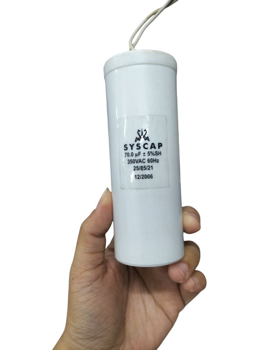 Syscap 70MFD 350 VAC Running Capacitor held in hand for electrical circuitry and parts