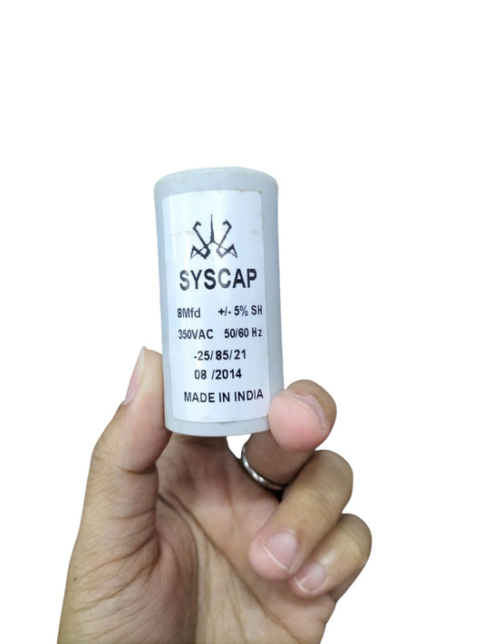 Syscap 8 Microfarad Motor Run Capacitor held in hand for electrical circuitry and motor applications