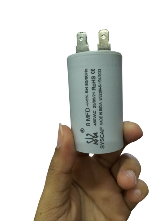 Hand holding Syscap 8MFD 450 VAC motor capacitor electrical circuitry part