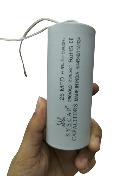 Syscap electrical motor capacitor 25 MFD 250VAC held in hand for electrical circuitry parts