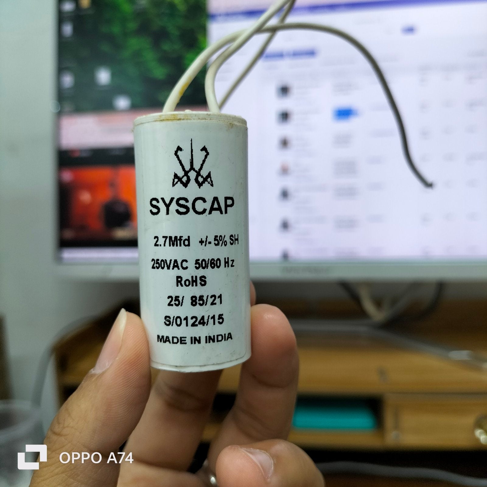 Syscap Motor Running Capacitor 2.7MFD250v white cylindrical electrical component held in hand
