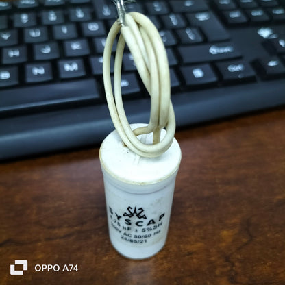 Syscap motor running capacitor 4.75MFD 250V with white cylindrical body and attached wire loop