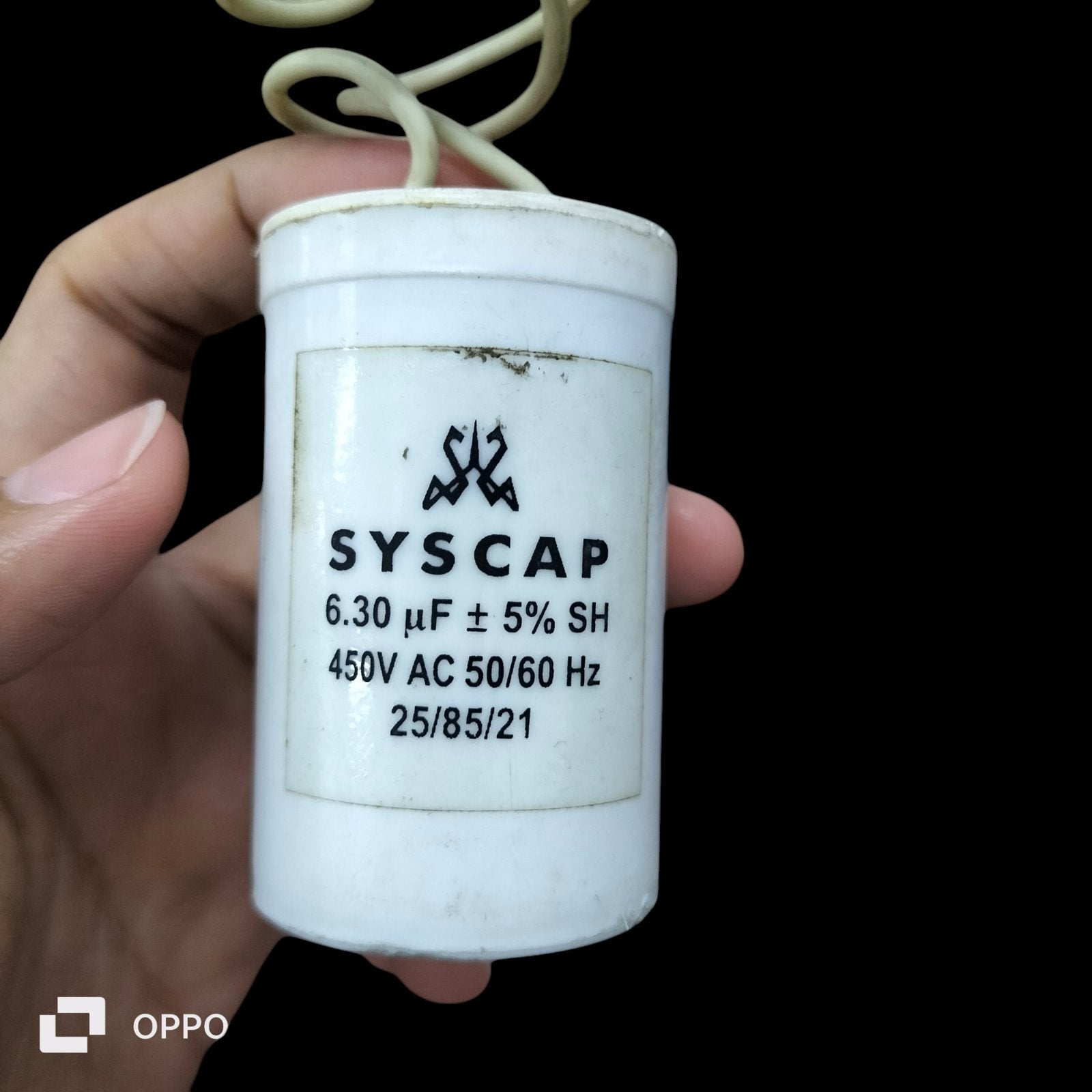Syscap electrical Run Capacitor 6.30 UF 450VAC held in hand for circuit applications