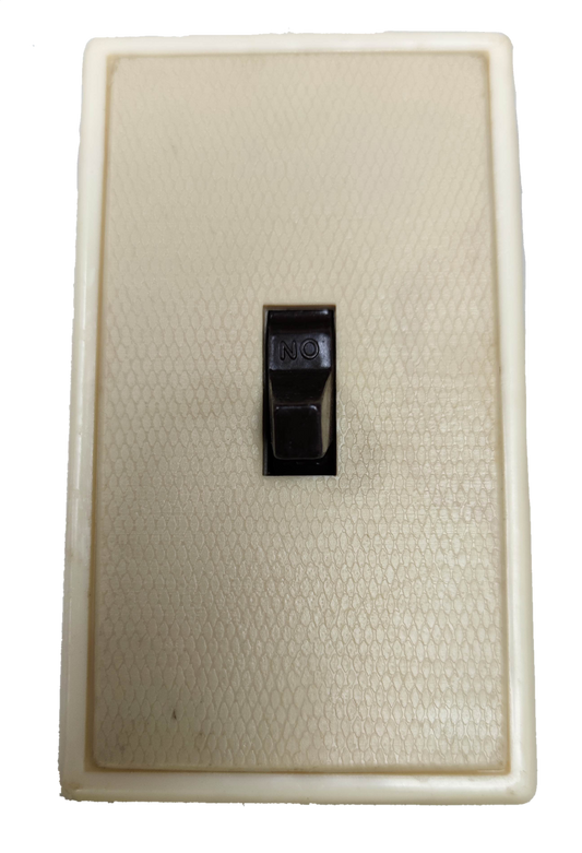 Kopez toggle light switch for home in black on a white textured wall plate