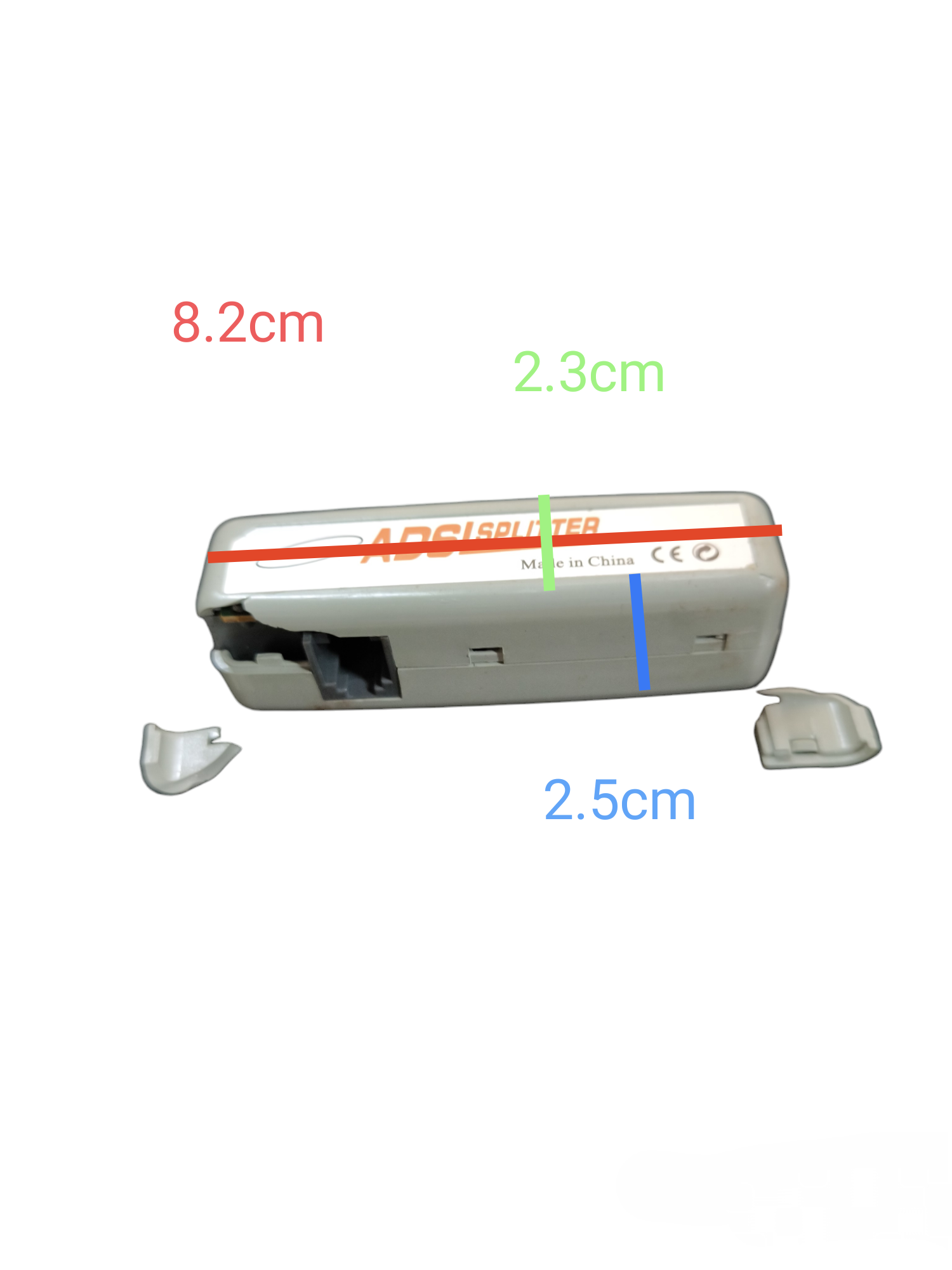 Small white ADSL splitter for telephone and internet. China made rectangular RJ11 jack with removable caps